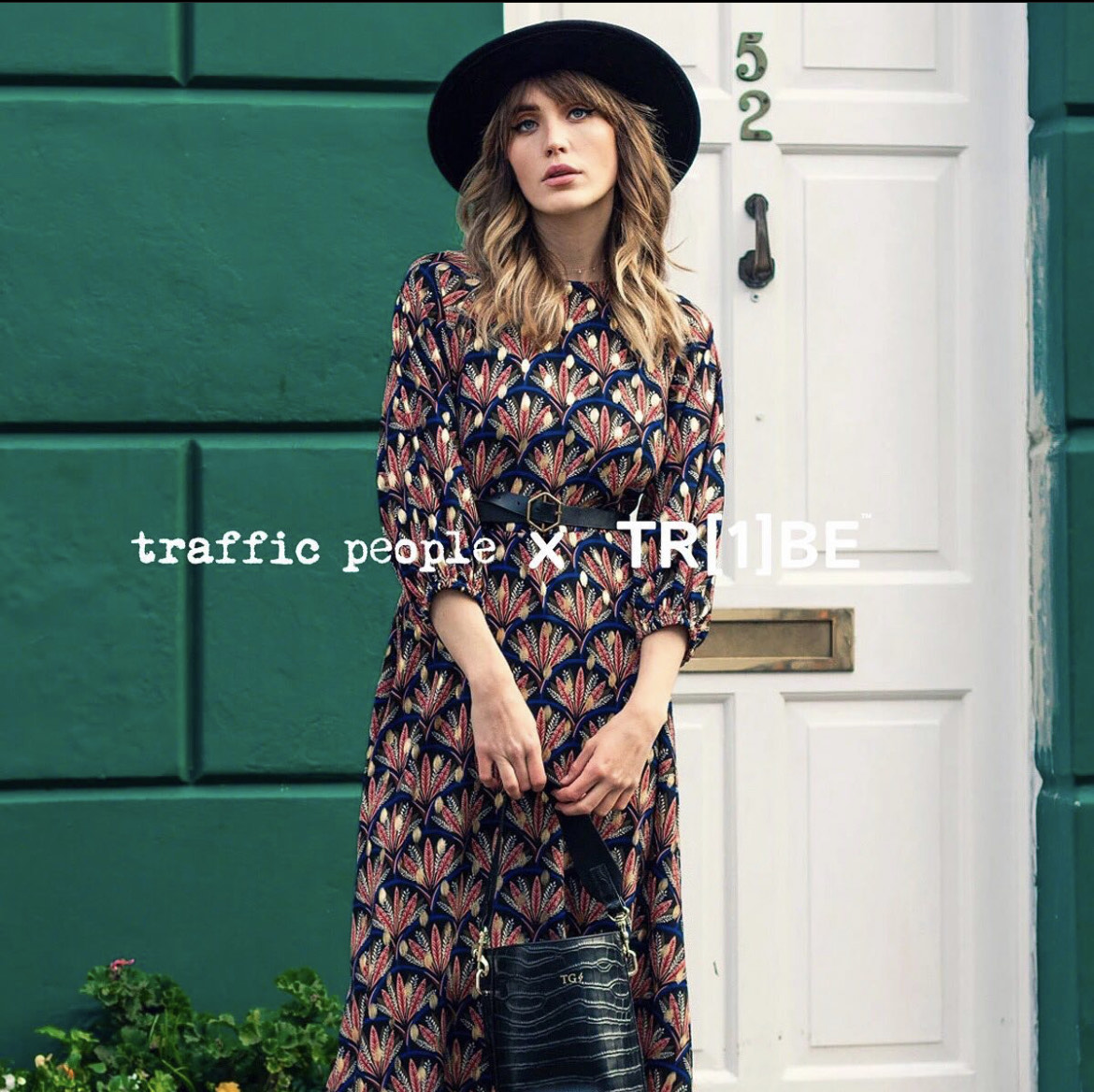 eco fashion brand Traffic people, woman standing in field wearing sustainable fashion