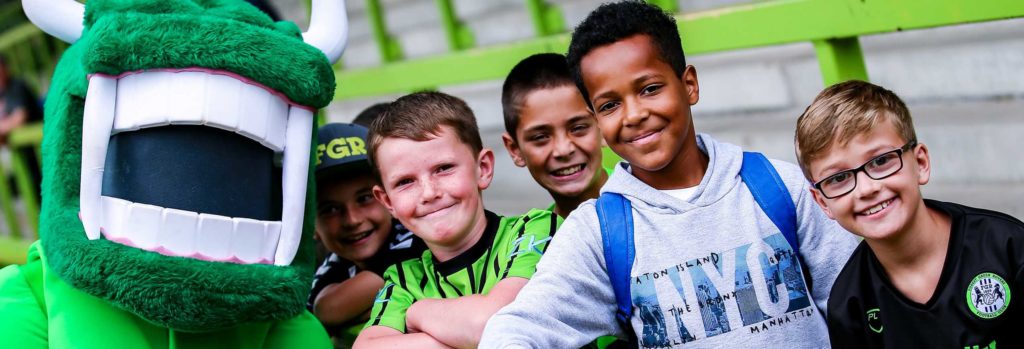 Children together with the Forest Green Rovers football team mascot