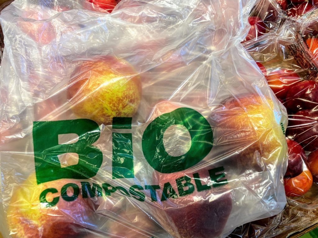 biodegradable plastic bag filled with red apples