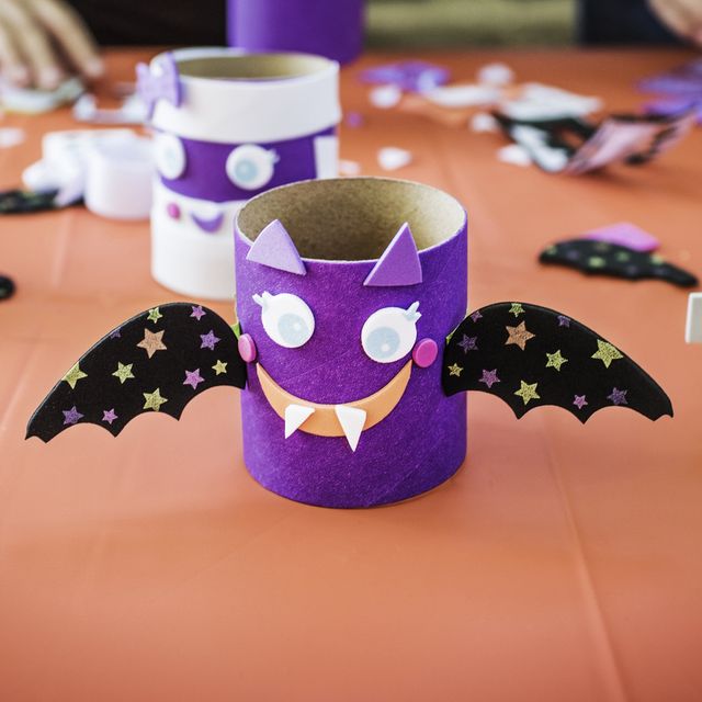 various-halloween-decoration-at-table-with-people