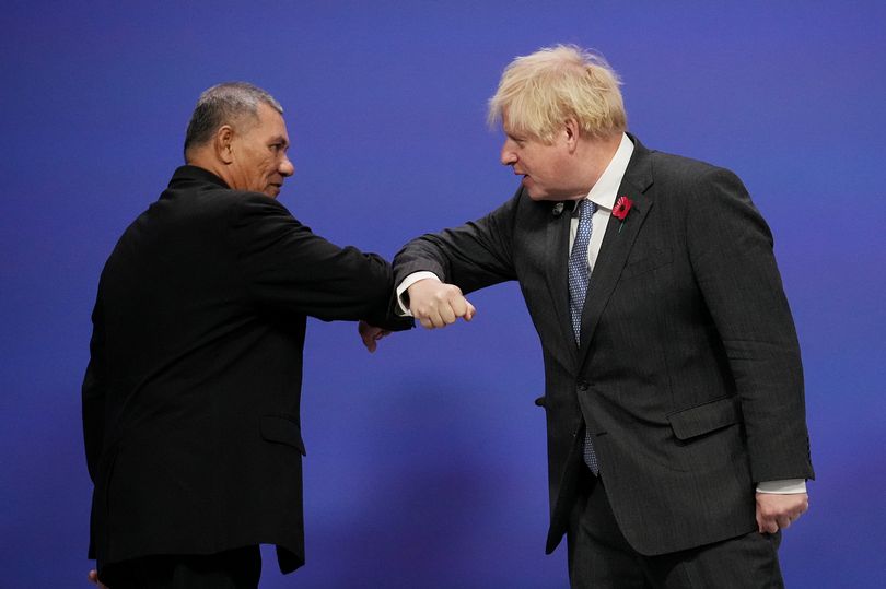 world leaders British Prime Minister Boris Johnson and Tuvalu Prime Minister Kausea Natano greet eachother at COP26. photo credit: dailyrecord.co.uk