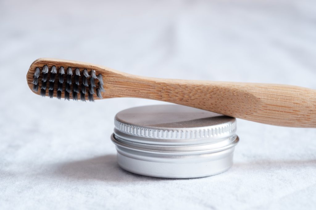 bamboo toothbrush in bathroom with charcoal bristles