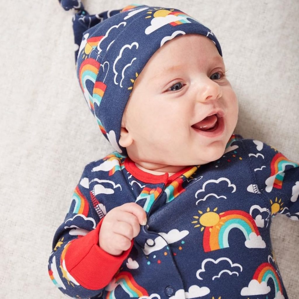 sustianable baby brands frugi navy blue rainbow baby grow suit